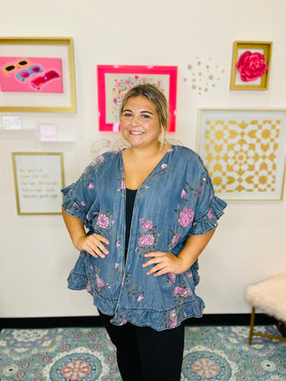 Woman wearing a floral denim jacket in an art gallery setting