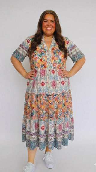 Woman wearing a colorful floral dress on a white background