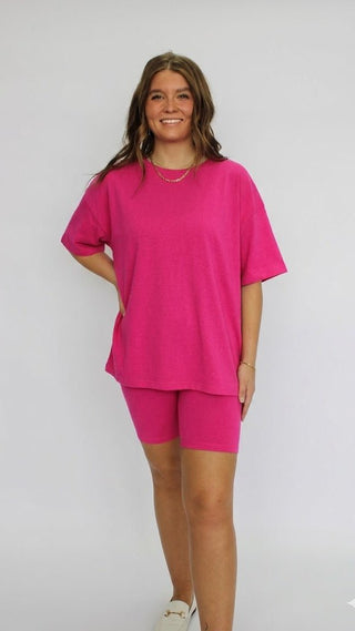 Woman wearing a bright pink outfit on a white background